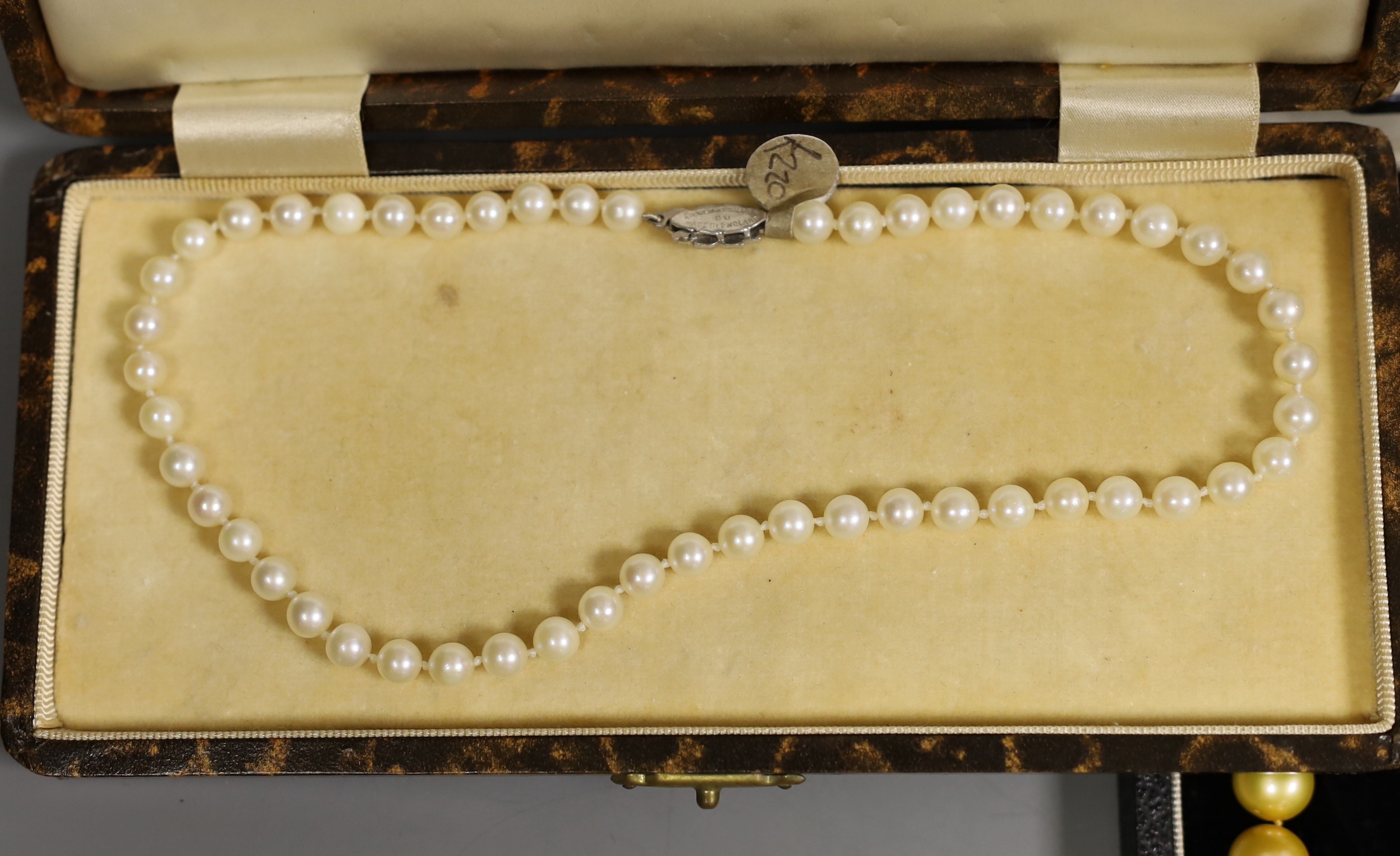 Four assorted cased single strand cultured pearl necklaces, with yellow metal or sterling clasps, longest 48cm.